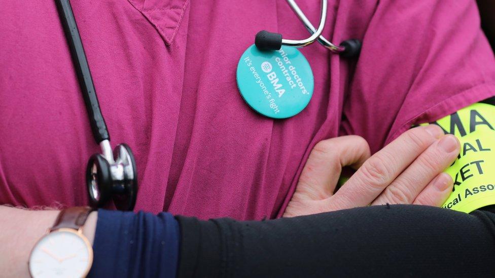 A junior doctor on strike wearing a badge, 'junior doctors' contract... It's everyone's fight'