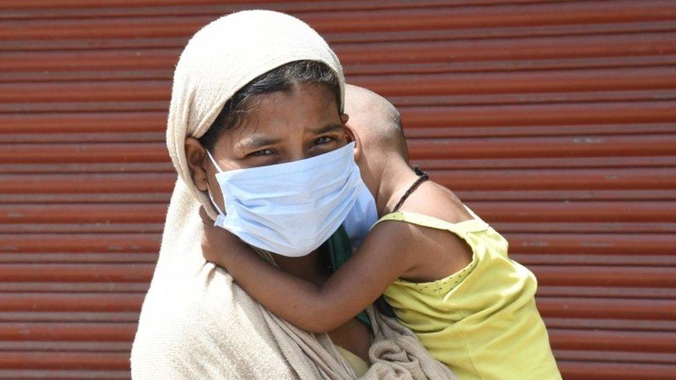 Woman and son wait for testing in Delhi