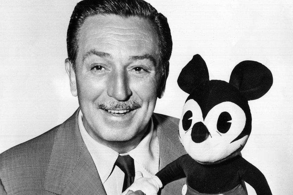 Walt-Disney-holds-Mickey-Mouse.