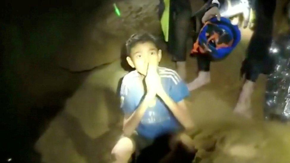 Boys from the under-16 soccer team trapped inside Tham Luang cave greet members of the Thai rescue team in Chiang Rai