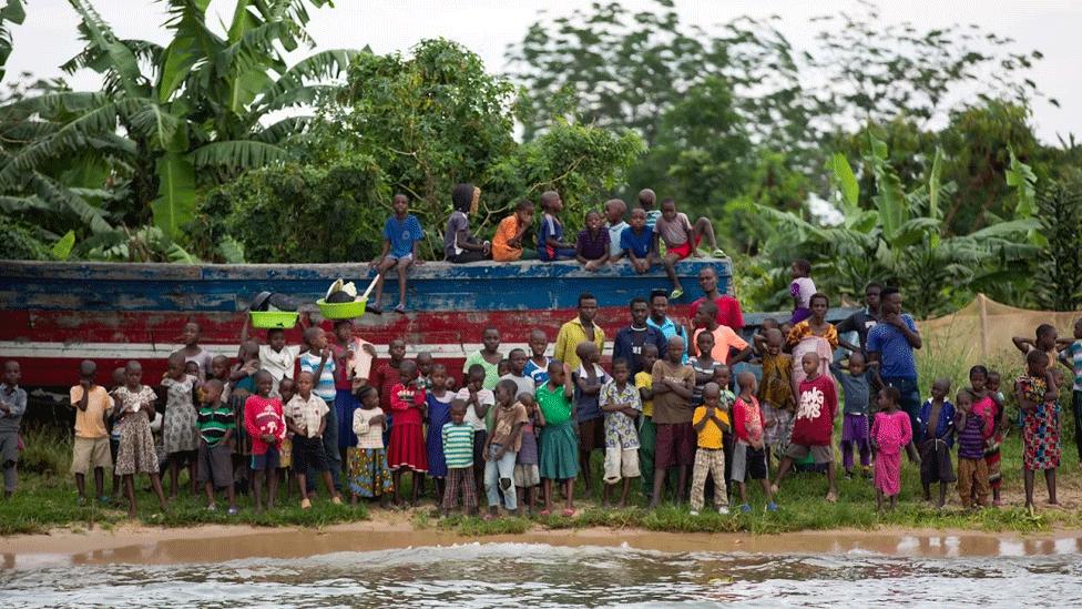 Children gathered at edge of shore