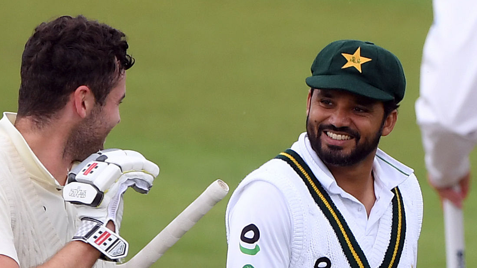 England"s Dom Sibley shares a joke with Pakistan"s Azhar Ali