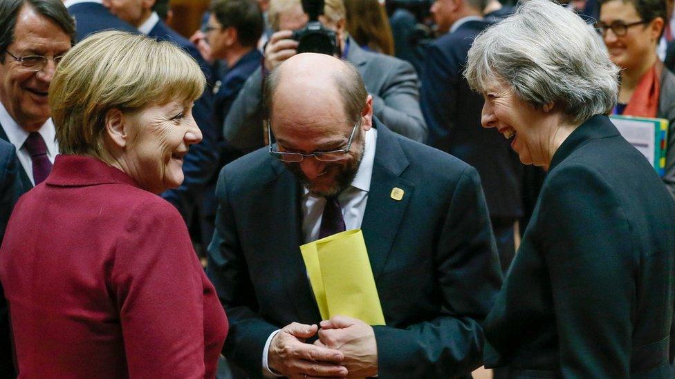 Theresa May shares a joke with German Chancellor Angela Merkel and European Parliament president Martin Schulz