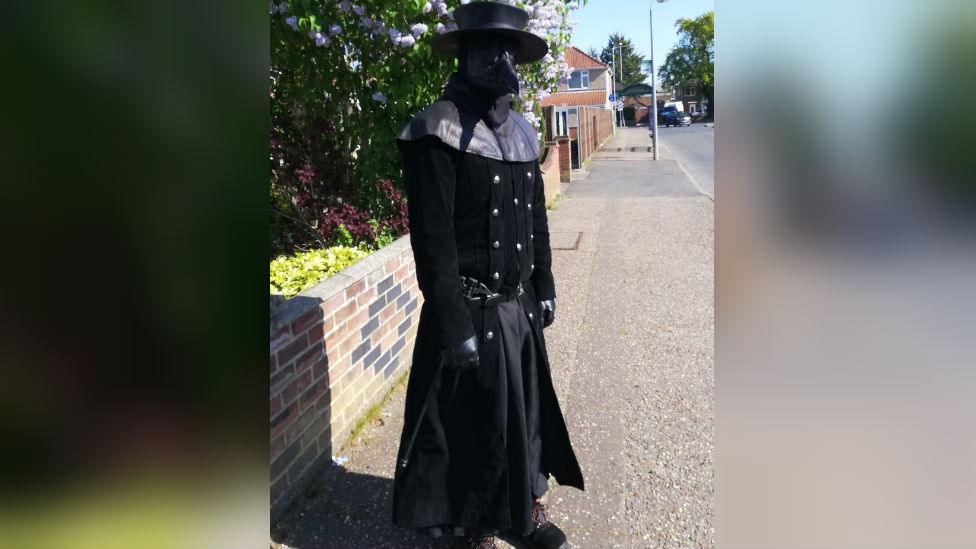 Person dressed as plague doctor