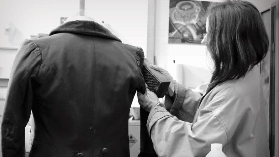 A jacket being 'broken down' using a grater