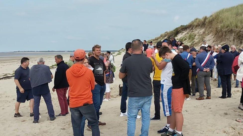 People gathered on Armanville beach in Normandy