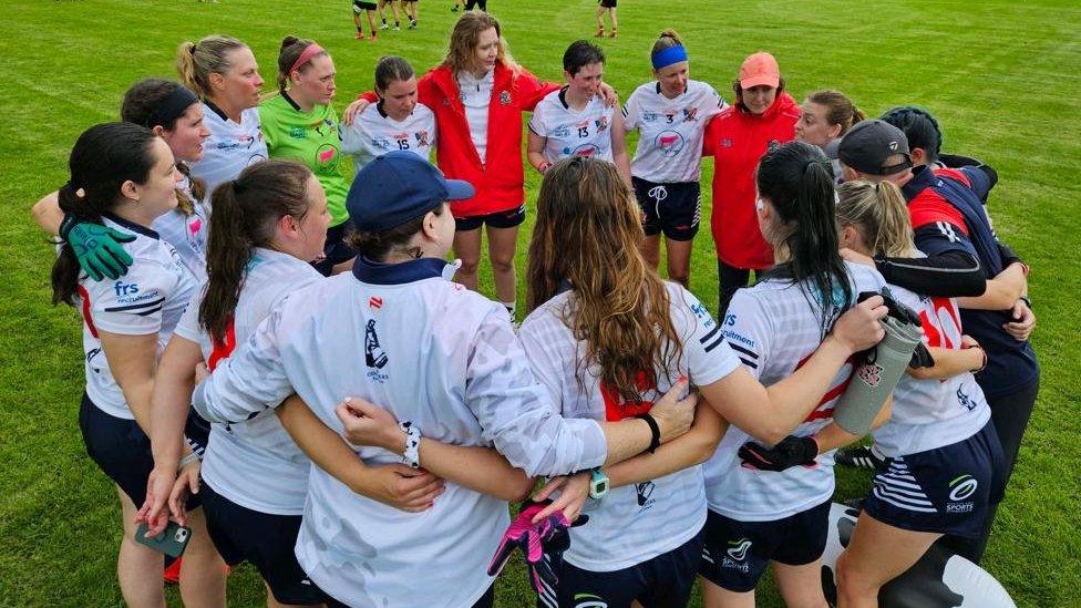 Members of the Hartland Dairy Girls in a pre-match meeting