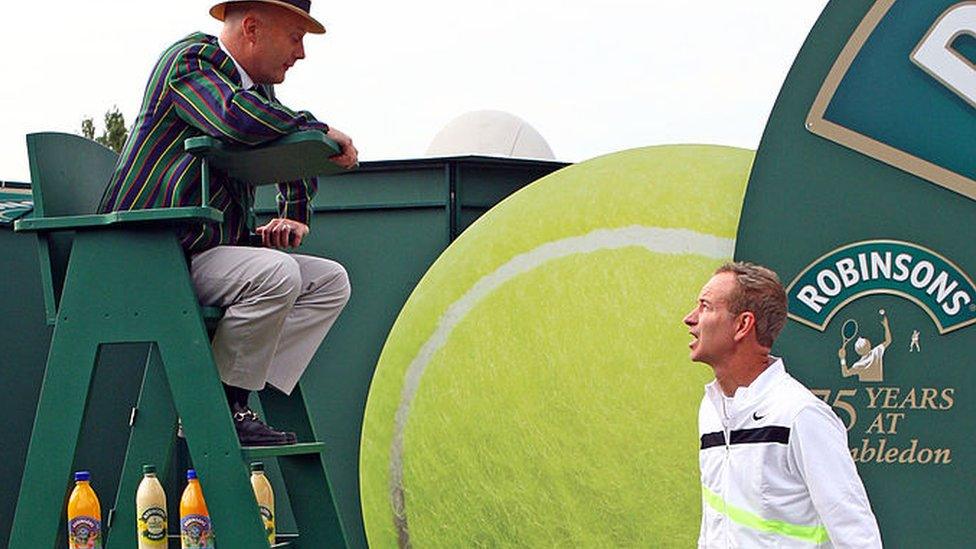 John McEnroe poses for photos to celebrate Robinson's 75th anniversary of their partnership with Wimbledon in 2010