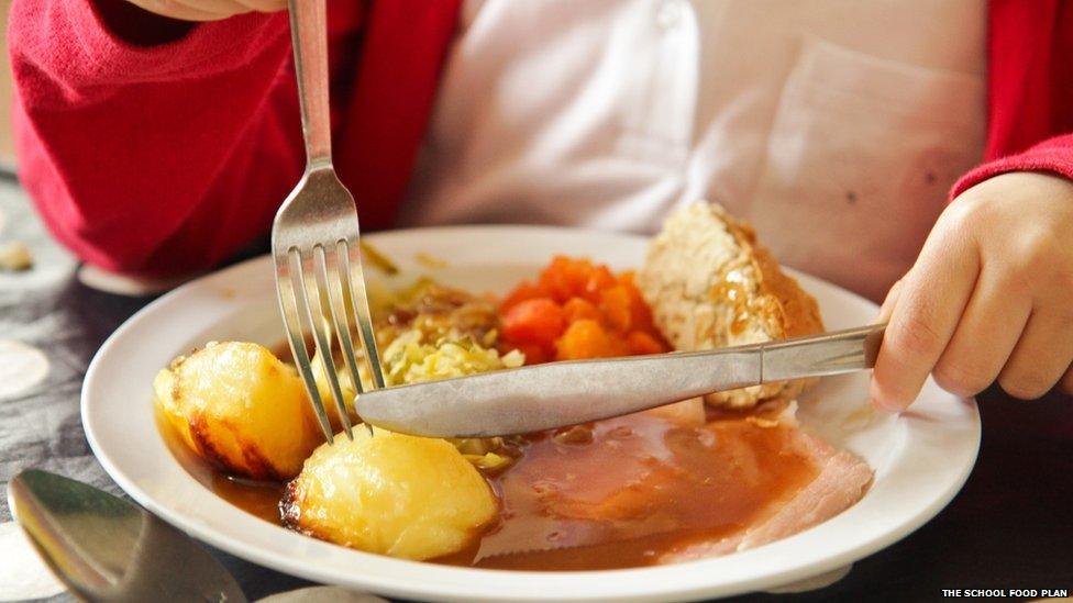 Healthy school roast dinner being eaten as part of The School Food Plan at Ashton Vale school in Bristol.