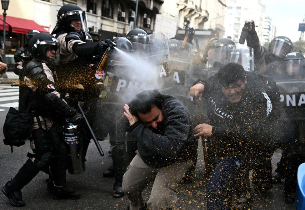 Riot police use pepper-spray on demonstrators during a protest outside the National Congress in Buenos Aires on September 11, 2024. 