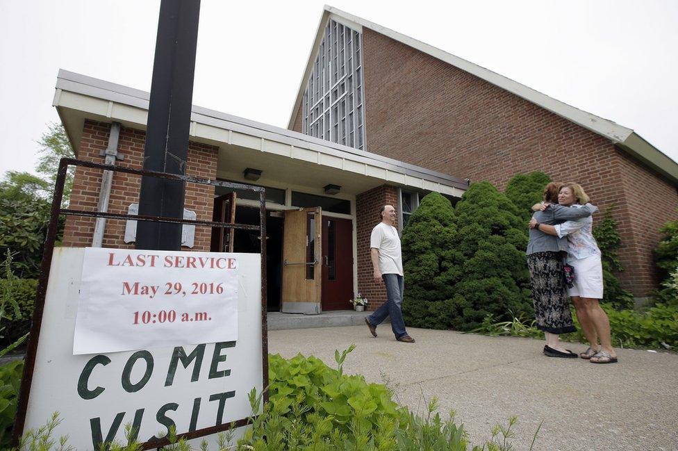 Churchgoers hug outside church