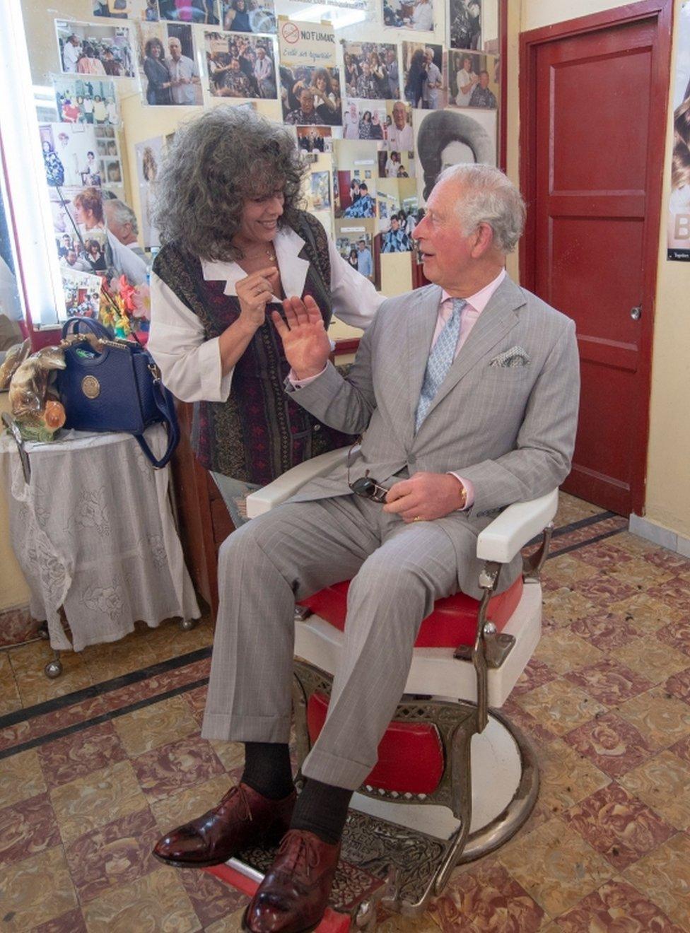 Prince Charles sat in the Barbers chair