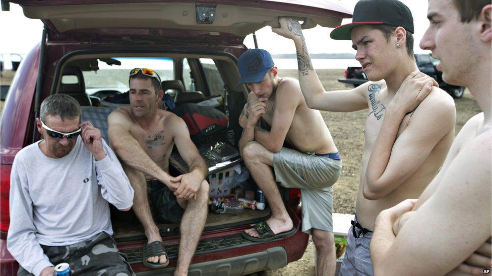 Topless and homeless they spent the night in their van after being evacuated from their homes in Alberta, Canada.