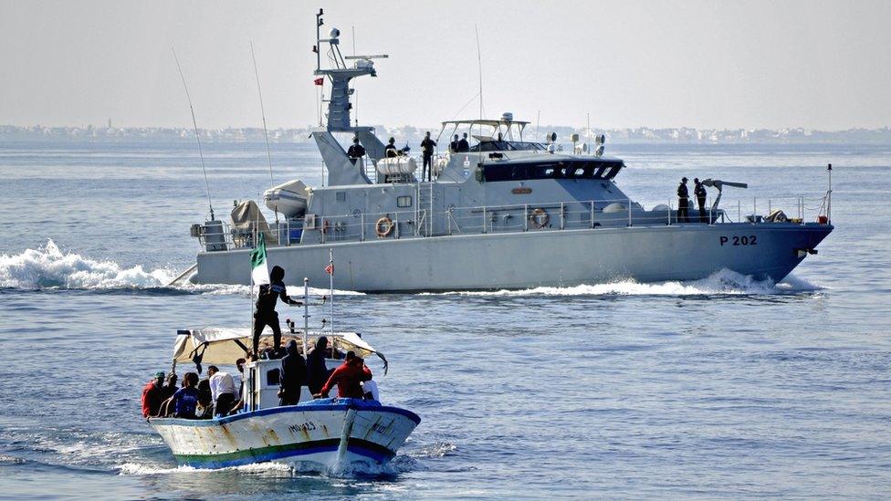 Tunisian Croissant Sportif Chebbien (CSC) football fans, who have threatened for weeks to emigrate to Italy in protest over sanctions against their club, board fishing boats on November 12, 2020 in the Mediterranean port of Chebba, accompanied by the Tunisian coast guard.