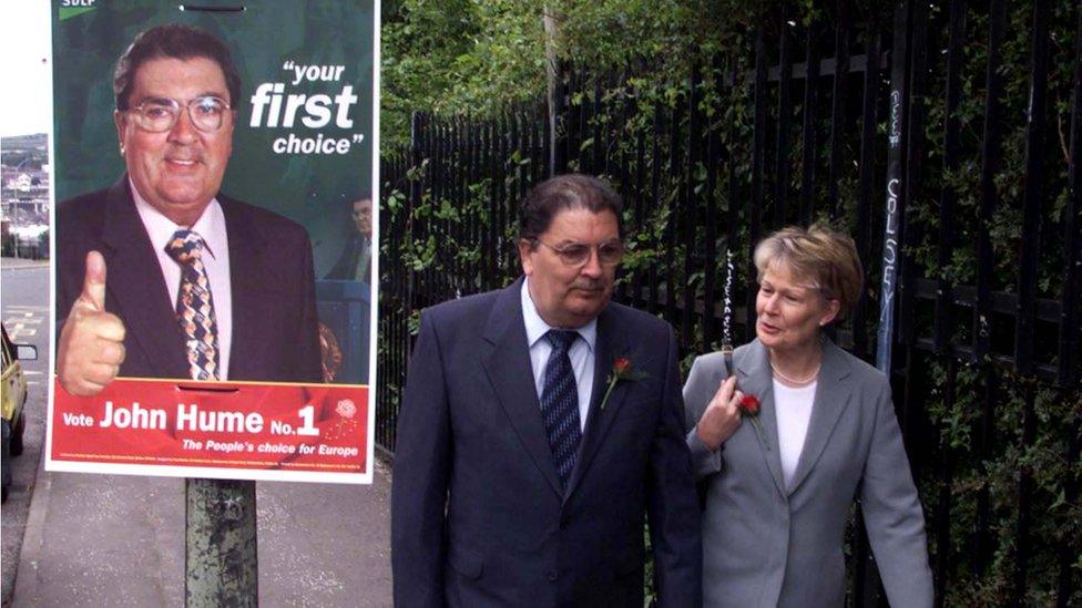 John and Pat Hume pictured beside a John Hume election poster in 1999