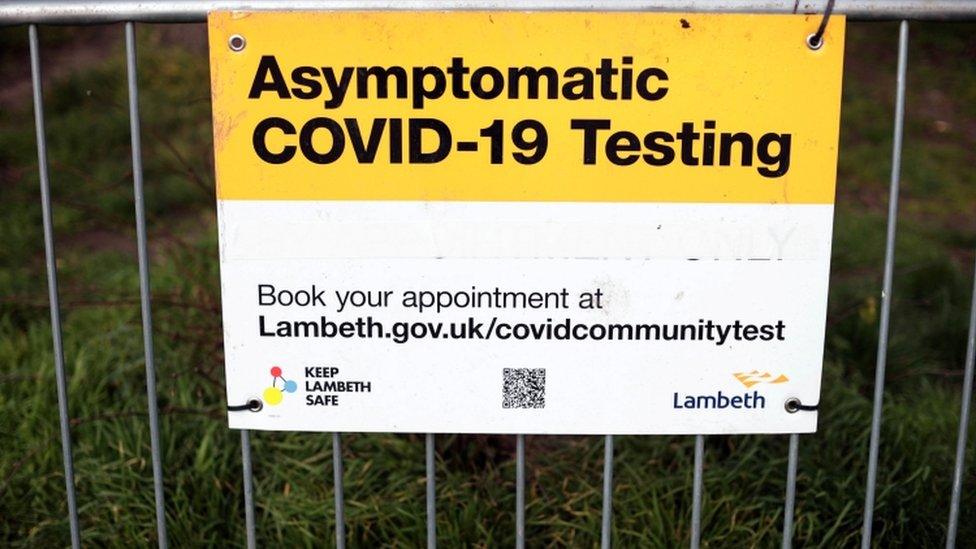 A sign urging people to book a test