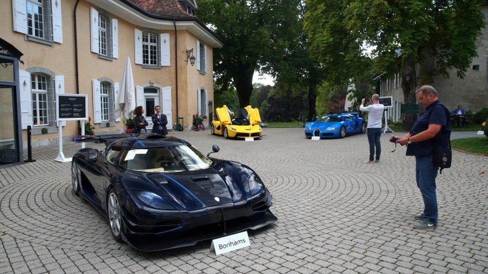 Luxury cars are displayed at an auction in the Swiss village of Cheserex, near Geneva