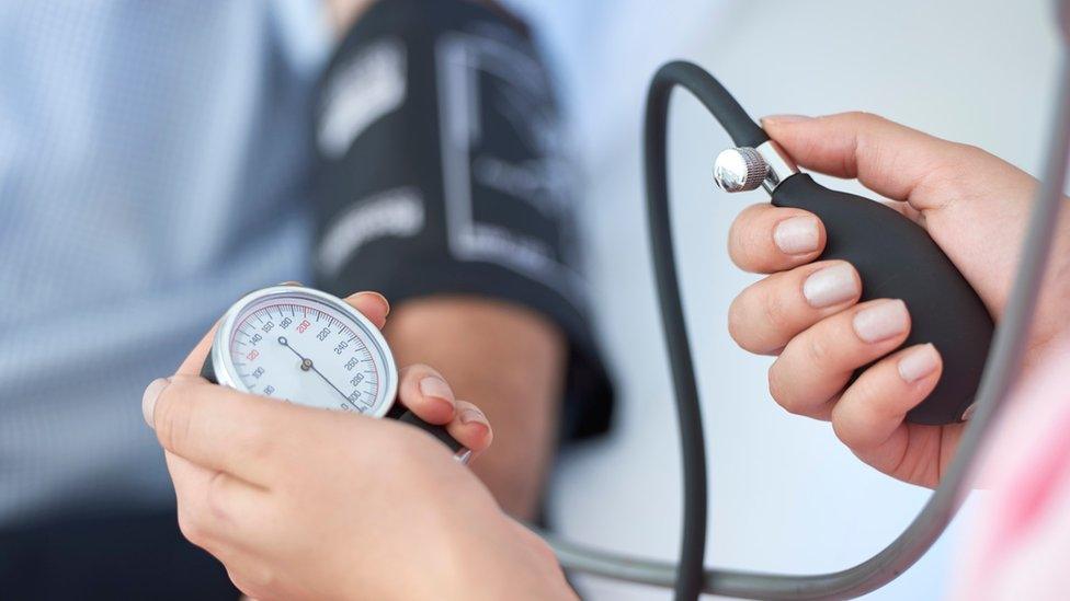 A nurse measuring blood pressure