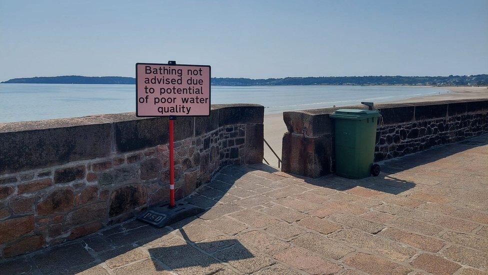 Sign advising people not to swim in St Aubin's bay