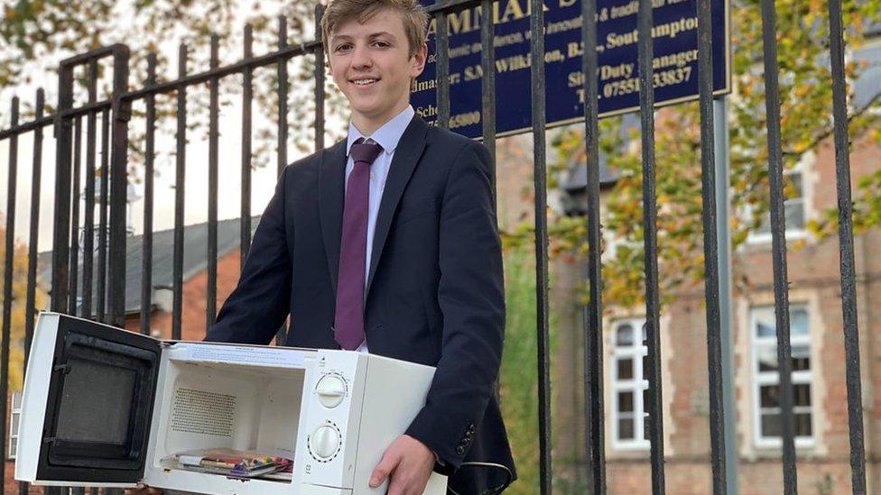 Kid carrying a microwave