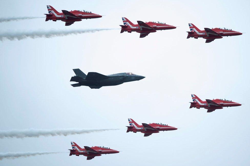 The RAF's Red Arrows and a new RAF F-35 jet perform a joint flypast