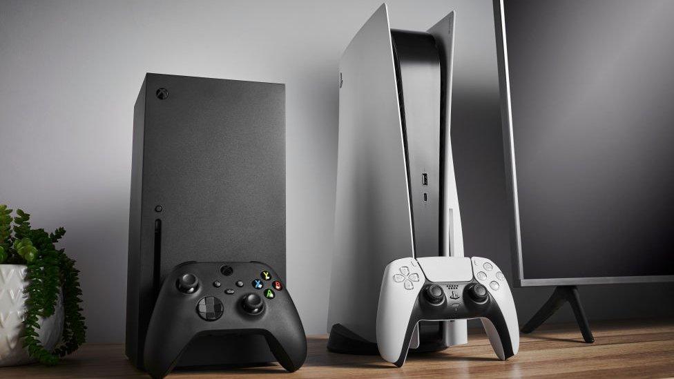 An Xbox Series X and a PlayStation 5 sit side-by-side