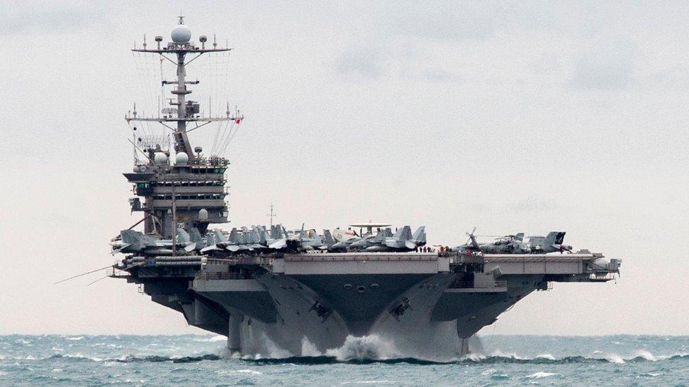 In this Saturday, Dec. 26, 2015 photo released by the U.S. Navy, the aircraft carrier USS Harry S. Truman transits the Strait of Hormuz.