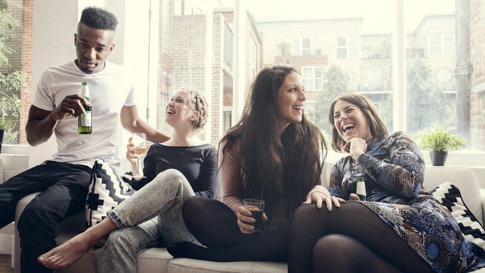 A group of friends at a house party drinking