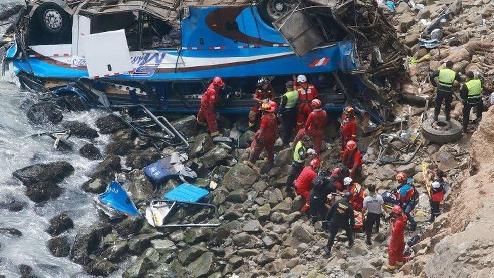 A handout photo made available by Agencia Andina shows a group of emergency personnel working to rescue victims after a passenger bus plunged off the Pan-American Highway North, about 45 kilometers from Lima, Peru, 02 January