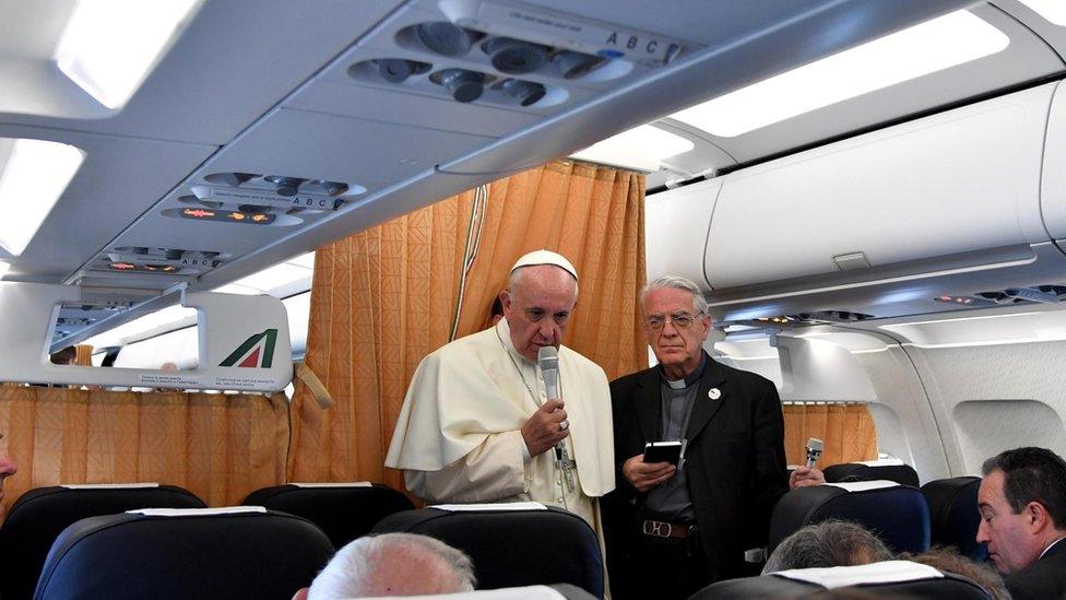 Pope Francis, flanked by Vatican spokesman Federico Lombardi, talks to journalists on flight back to Vatican, at end of three-day visit to Armenia, Sunday, June 26