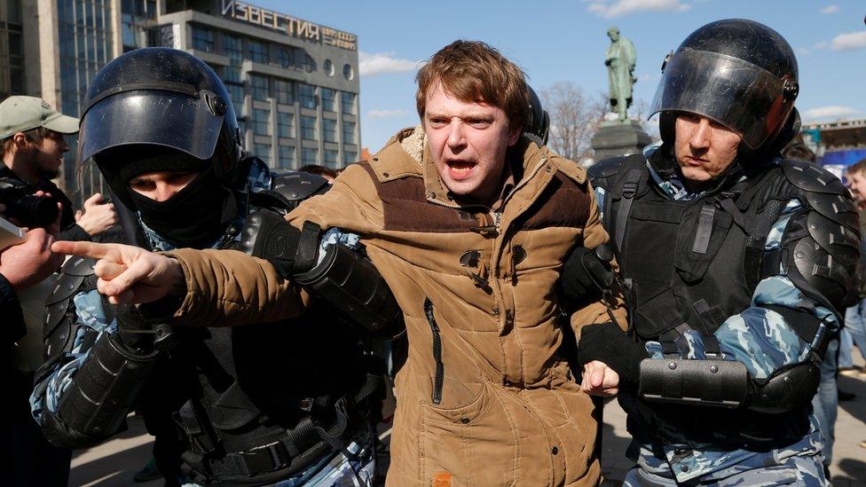 Police detain a protester in downtown Moscow