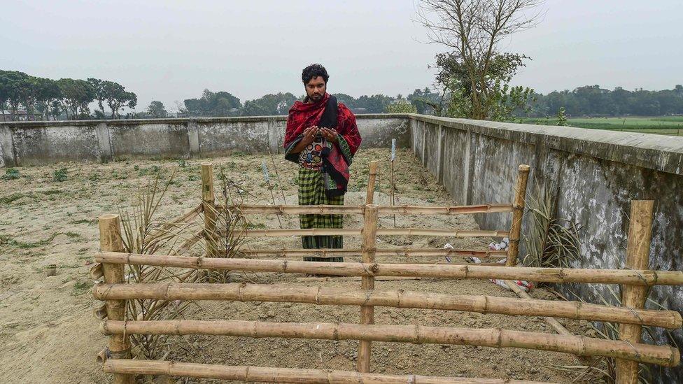 Hamida Begum's son Mukul Seikh at her graveside