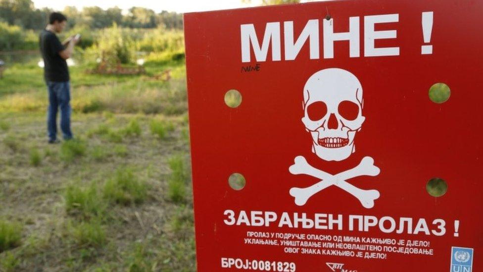 A man plays Pokemon Go near a mine field in Bosnia