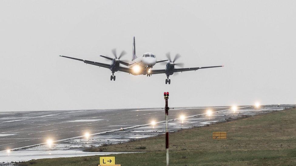 Plane lands at Leeds Bradford Airport in heavy wind.