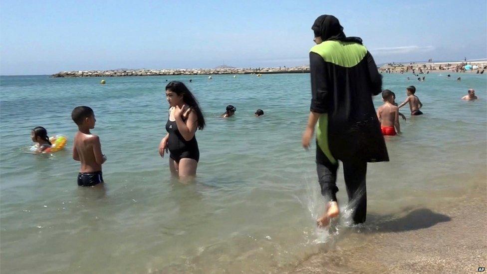 A woman in a Burkini at the beach.