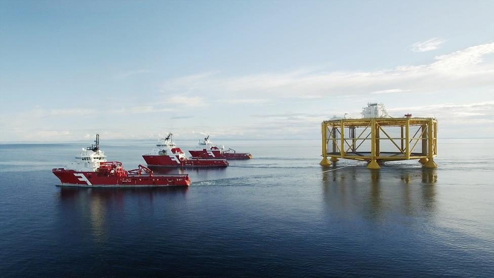 Ocean farm cage being towed