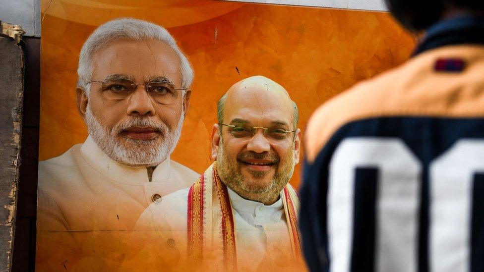 Poster of Indian Prime Minister Narendra Modi (L) and Bhartiya Janta Party President Amit Shah (R)