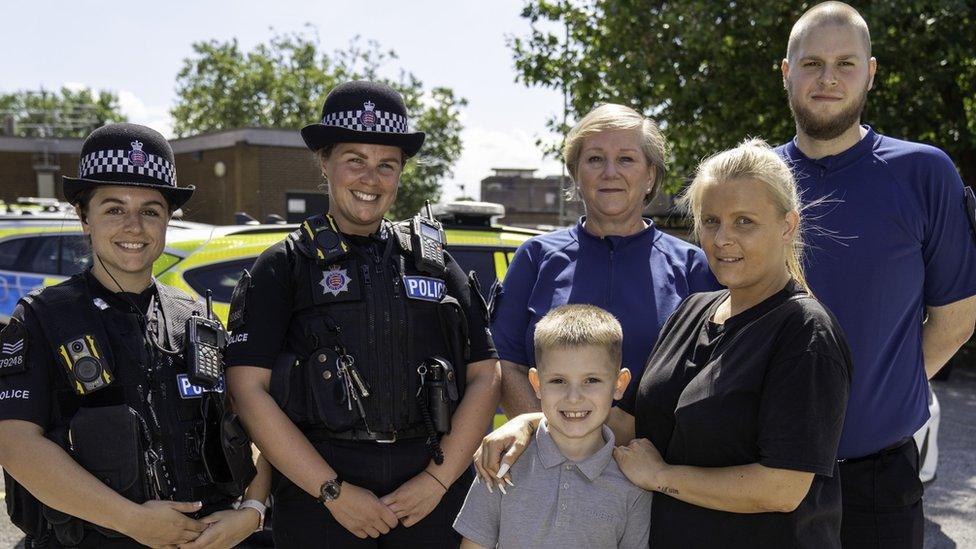 Ronnie-Lee and mum Becky with two police officers, call handler Ruth Potts and control room supervisor Adam Taylor