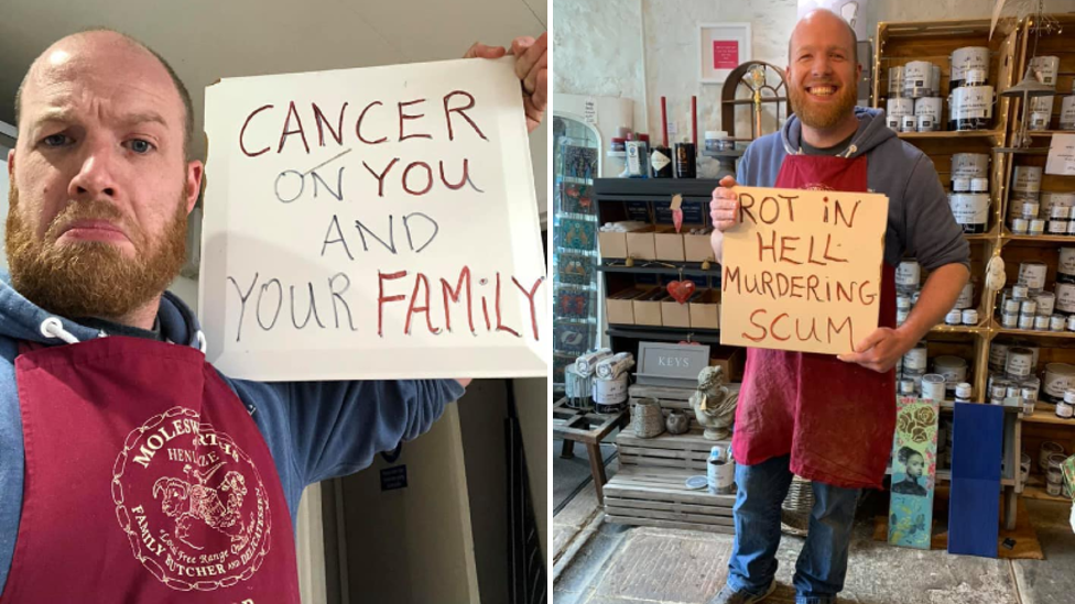 Man holding protest signs