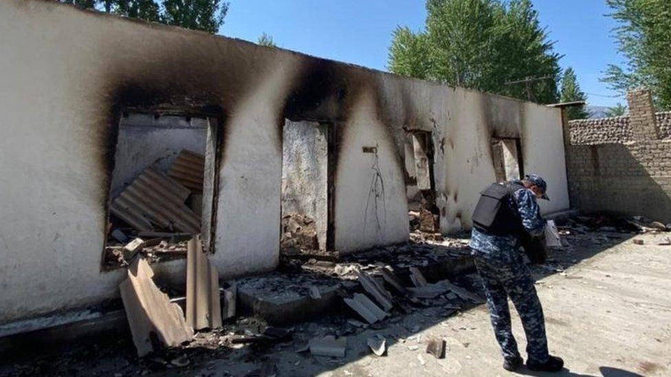 An official documents the damage to buildings in the area