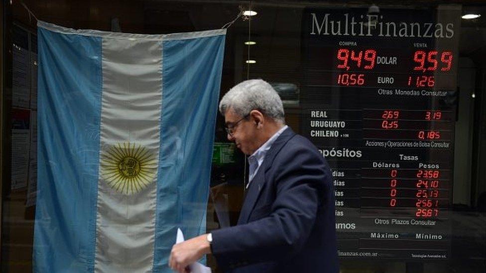 A man walks past a bureau of change in Buenos Aires' downtown on 13 October, 2015.