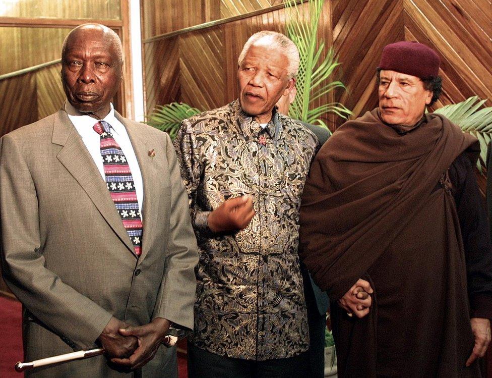 Daniel arap Moi alongside Nelson Mandela and Muammar Gaddafi in 2001.