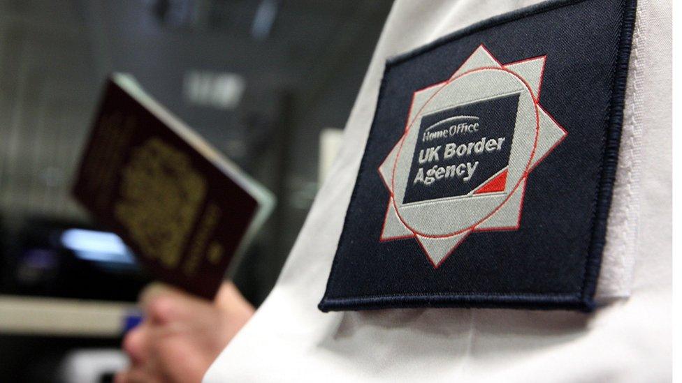 Officer checking a passport