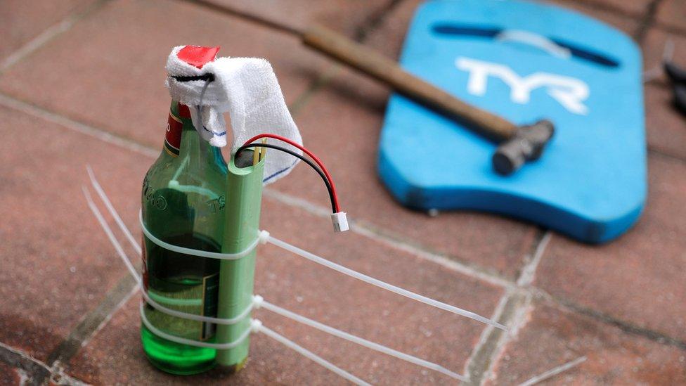 A Molotov cocktail and a hammer left on the roof of a university building