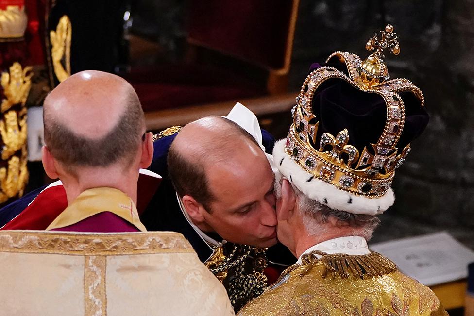 The Prince of Wales kisses his father King Charles III during his coronation ceremony in Westminster Abbey