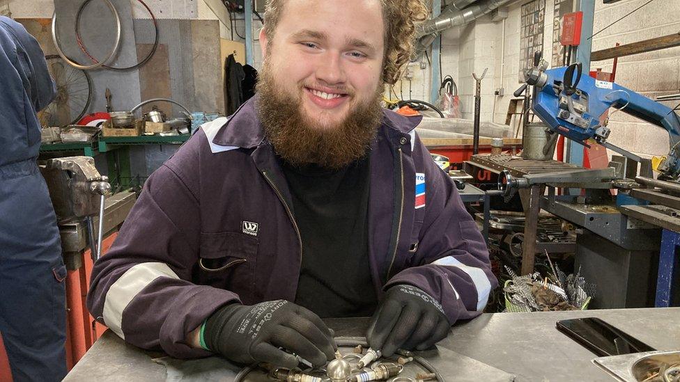 Young man working on parts for the bee