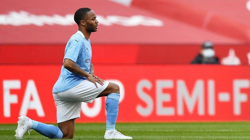 Manchester City striker Raheem Sterling taking a knee at an FA Cup semi-final in 2021