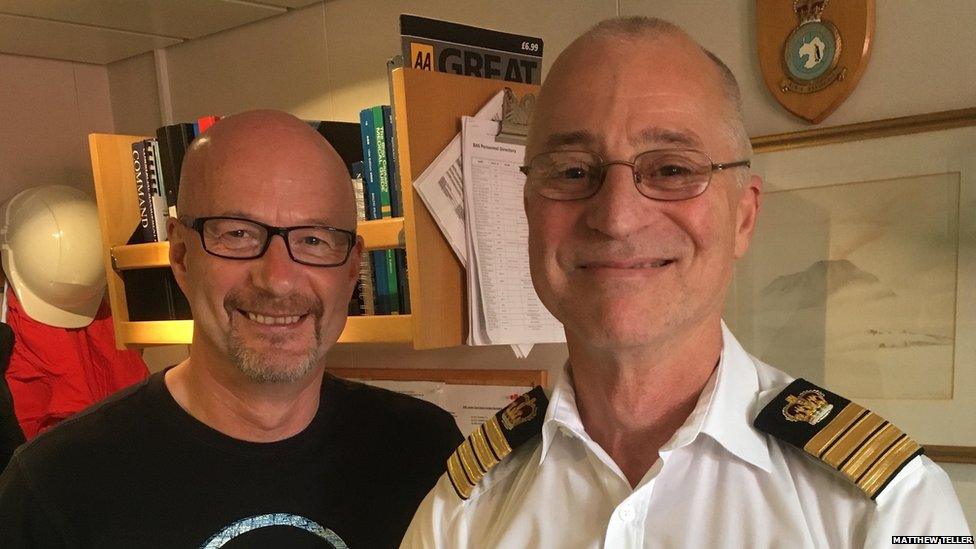 Peter Gibbs joined by Captain John Harper in a small office. There are books and a painting in the background.