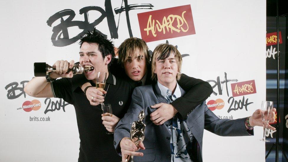 Busted's Matt Willis, Charlie Simpson and James Bourne holding their Brit awards