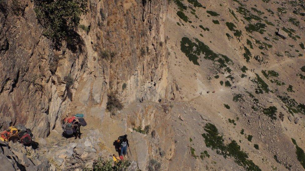 The trek to Boybuloq leads along narrow paths and steep rock faces